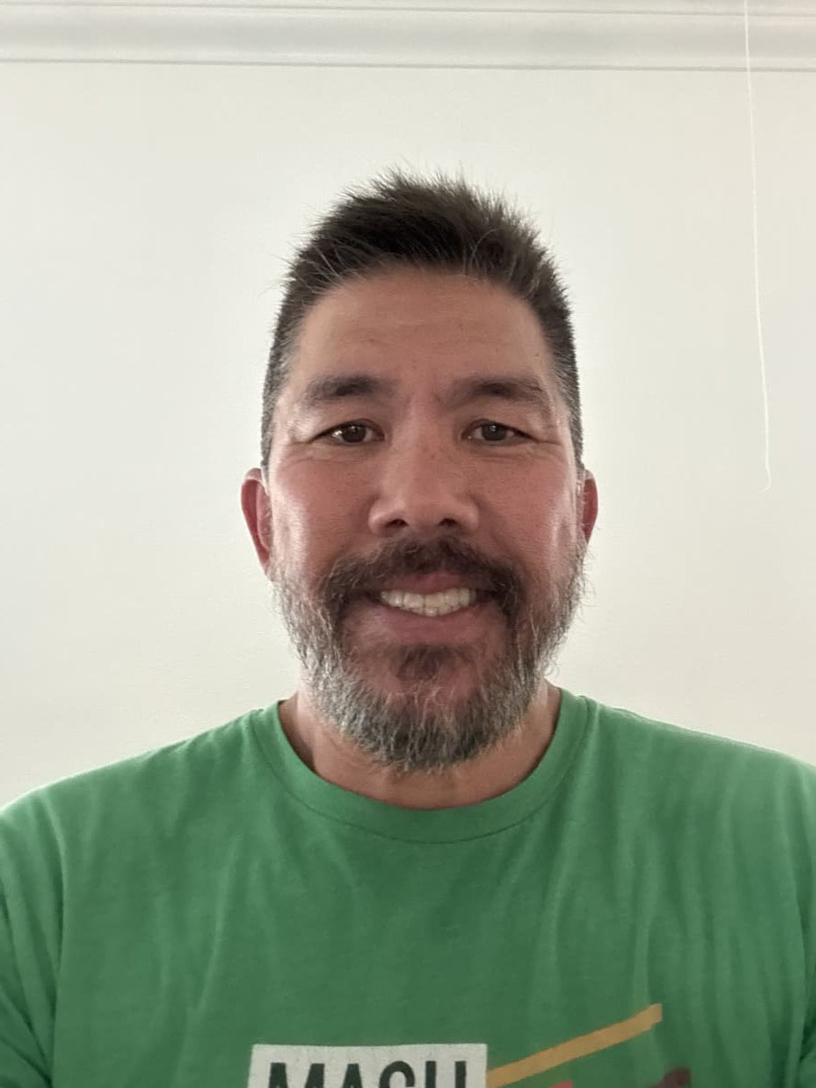 Man wearing a green t-shirt with text on a white background